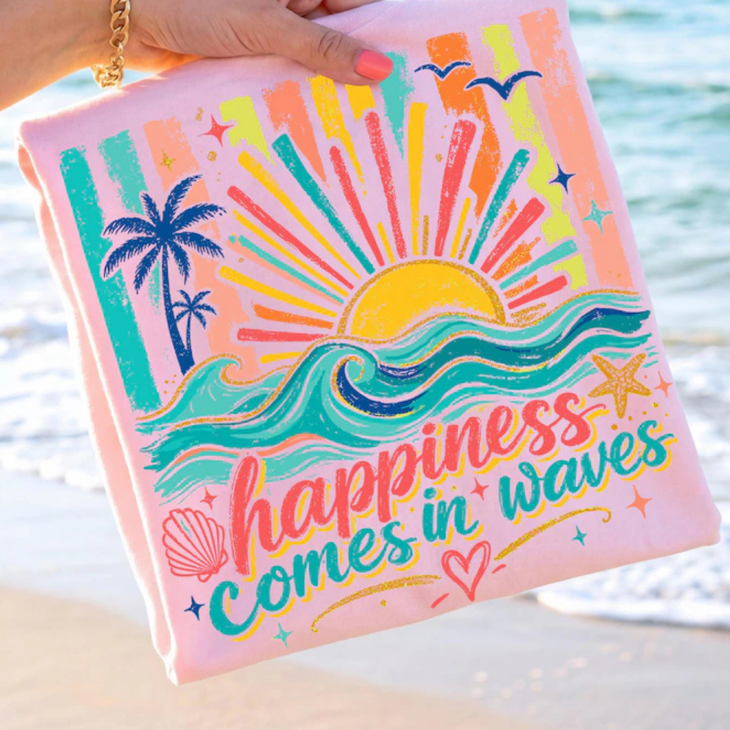 Colorful pouch with beach-themed design and 'happiness comes in waves' text held by a hand by the water.